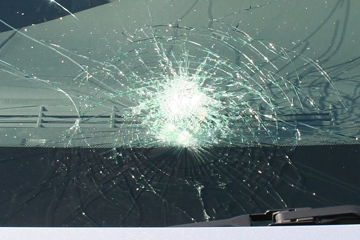 Cracked vehicle windshield showing damage that requires professional assessment