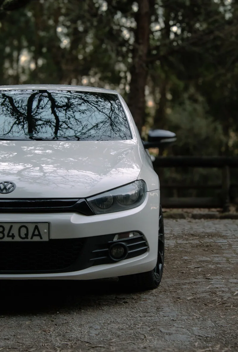 Parked white vehicle with an intact windshield ready for the road